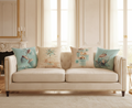 Beige sofa with decorative art deco cushions in a living room setting