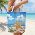 Tote bag with a starfish design held by a person on a beach.