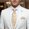 Man wearing a white suit with a gold paisley tie and pocket square.