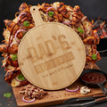 Wooden pizza board with 'Dad's Pizzeria' branding over a pizza with various toppings.