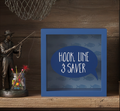 Fisherman money box gift with 'Hook, Line & Saver' text on a wooden shelf with fishing-themed decor.
