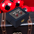 Red sports cufflinks in a blue gift box with a red background
