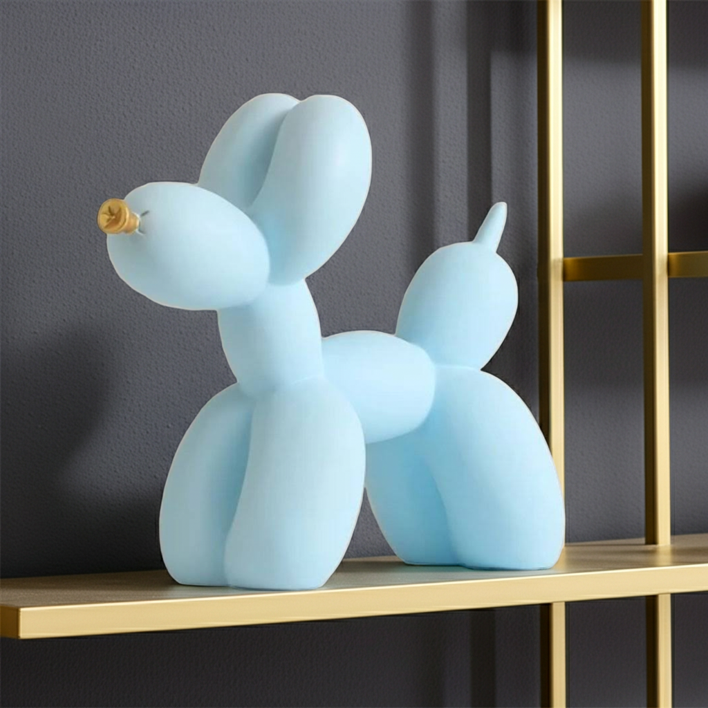 A light blue balloon dog sculpture on a gold shelf against a dark gray wall.