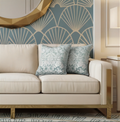 Beige sofa with decorative duck egg blue cushions against a wall with geometric pattern