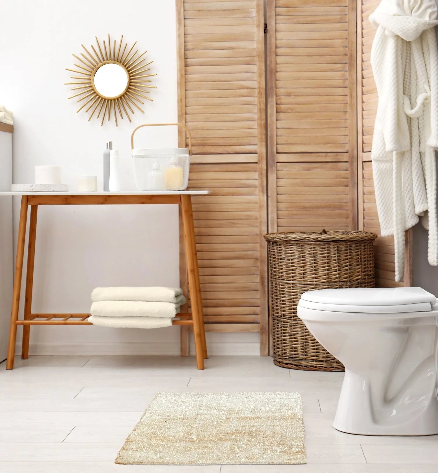 Bathroom with wooden vanity, toilet, and wicker basket showcasing sparkles beige small rug.